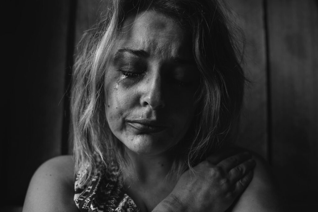 Black and white portrait of a crying woman.