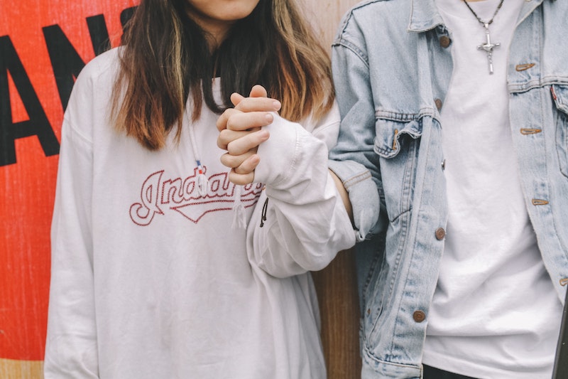 A couple holding hands of each other