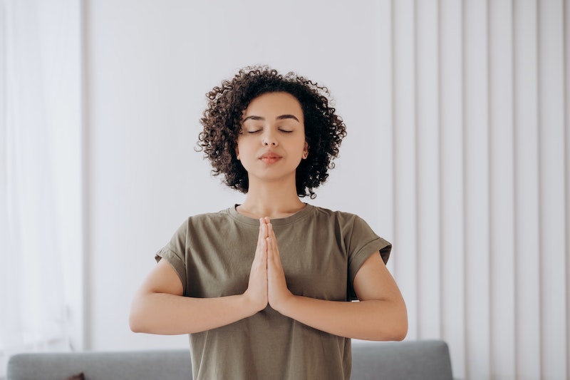 A woman with curly hair meditating