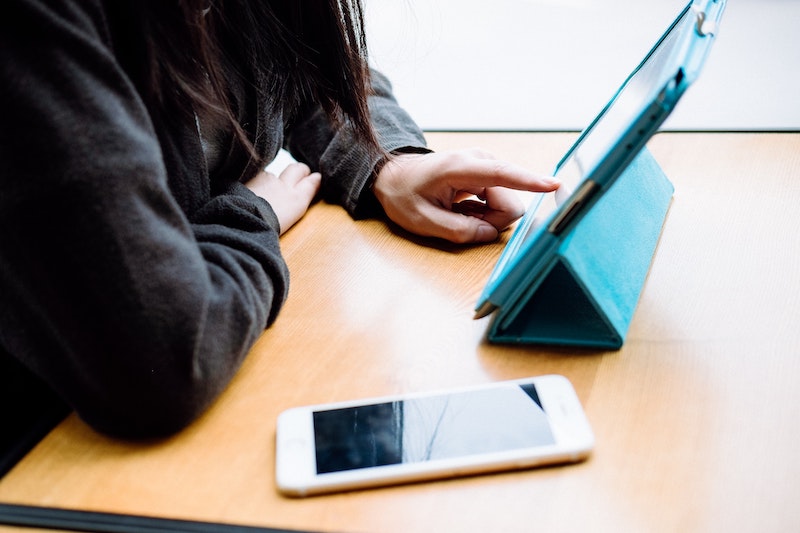 A woman working on a smart tablet