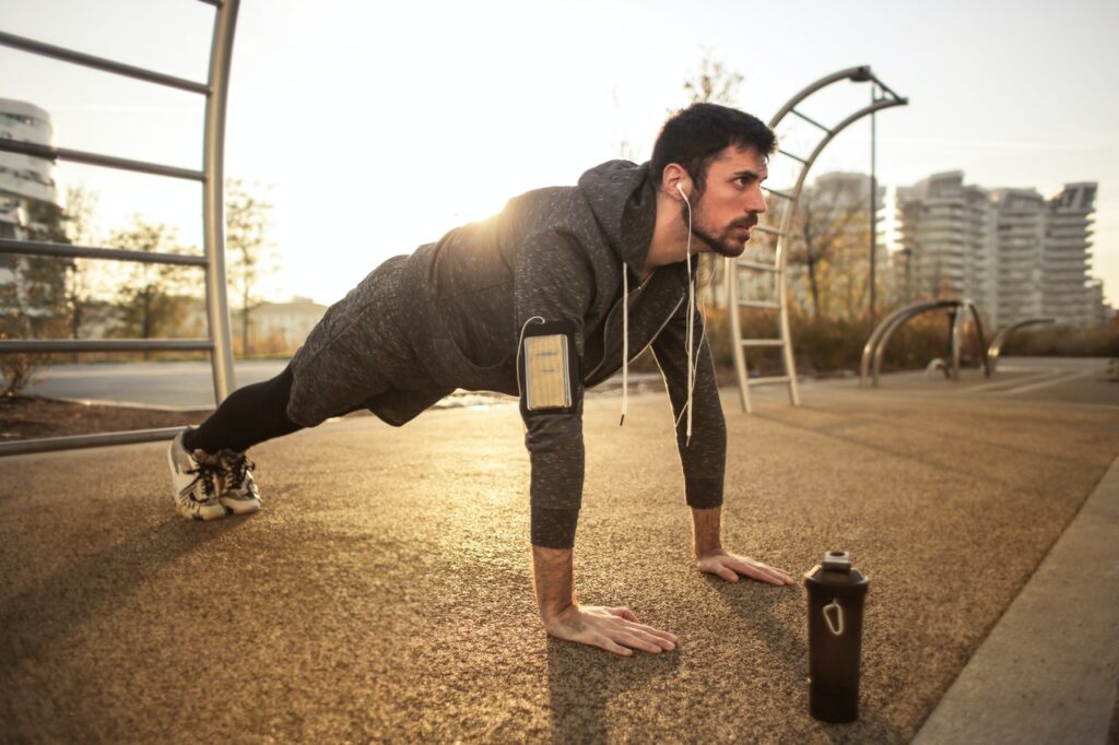 A man working out with a bottle in front of him